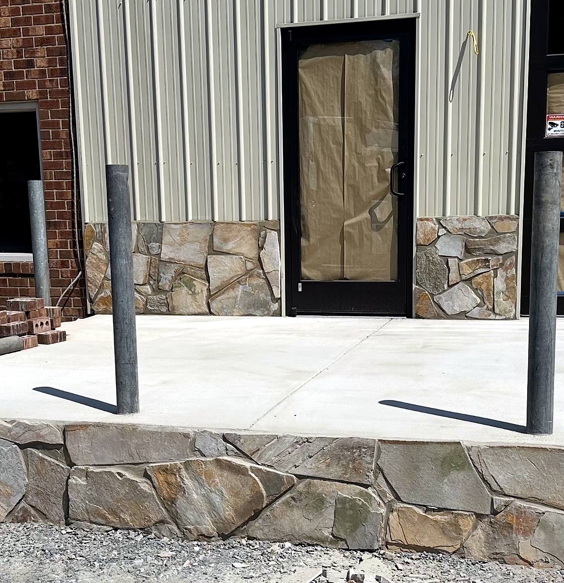 Concrete entry slab with stone veneer